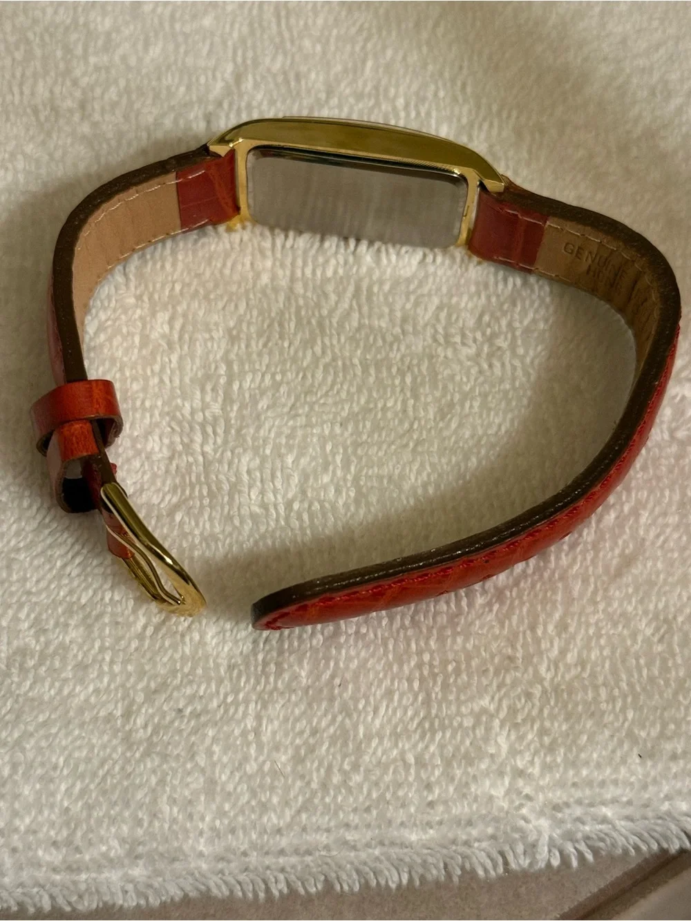 Clarins Gold-Tone Rectangular Watch with Red Strap and White Dial